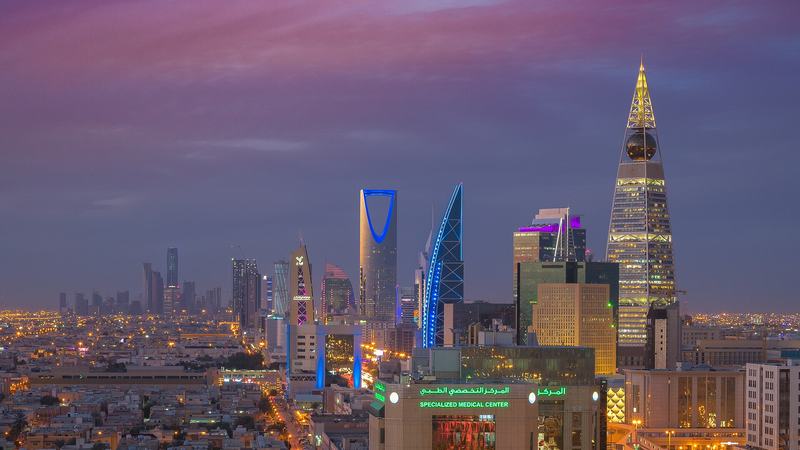 The Riyadh skyline at dusk with the Kingdom Centre tower