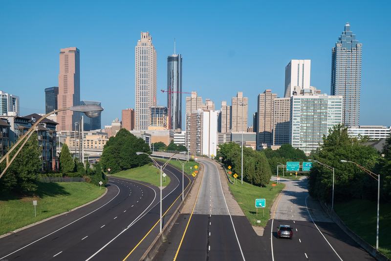 The downtown Atlanta skyline seen from a bridge over an empty highway